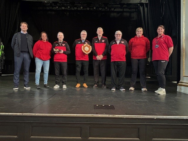 group photo on the Assembly rooms stage with a football shield