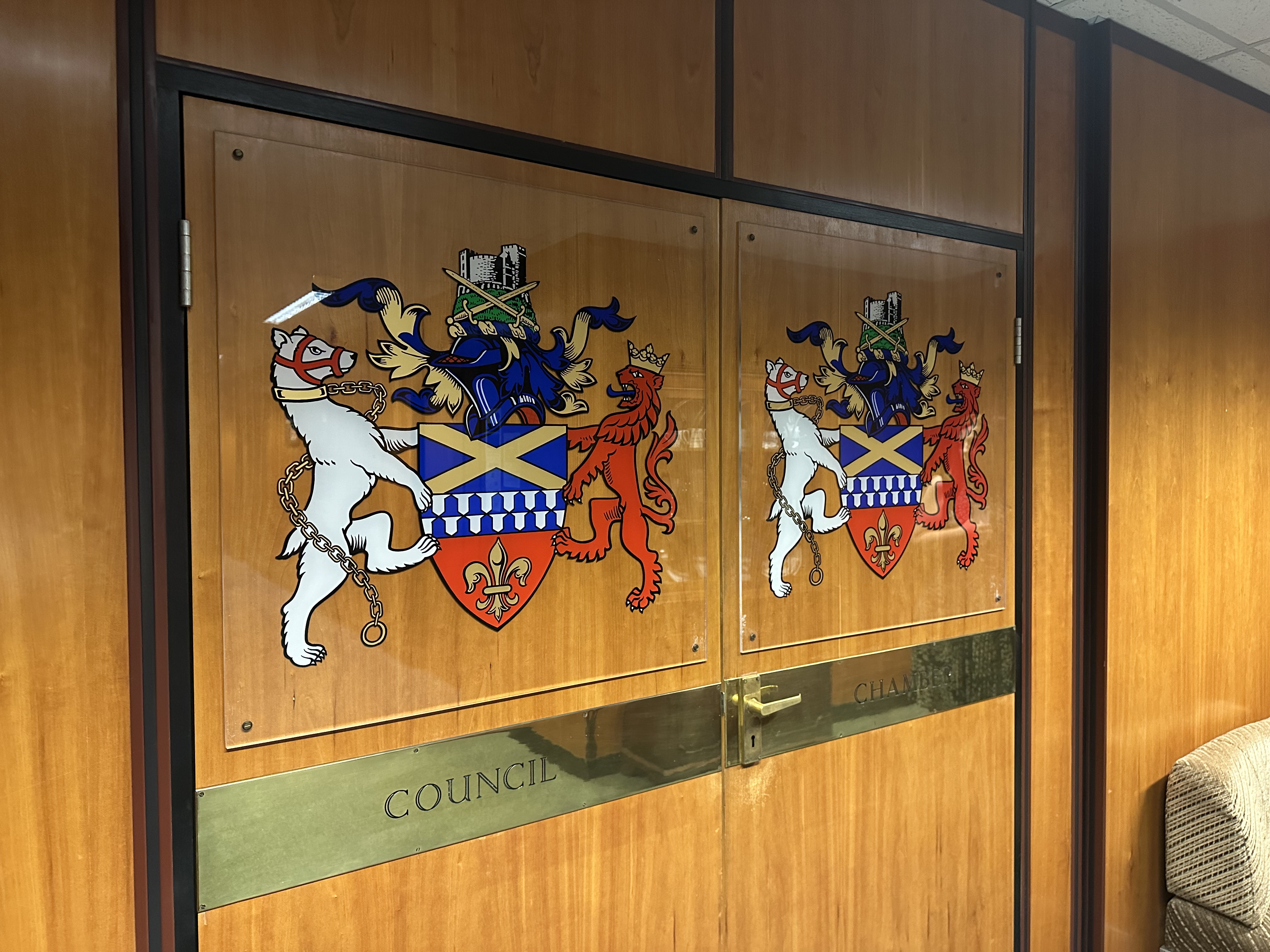 Two wooden doors with 'council chamber'