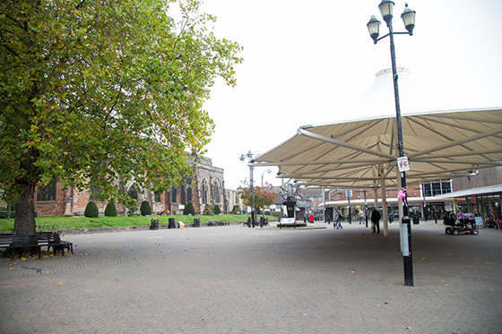 St Editha's Square with a tree on the left hiding the church and a white gazebo on the right