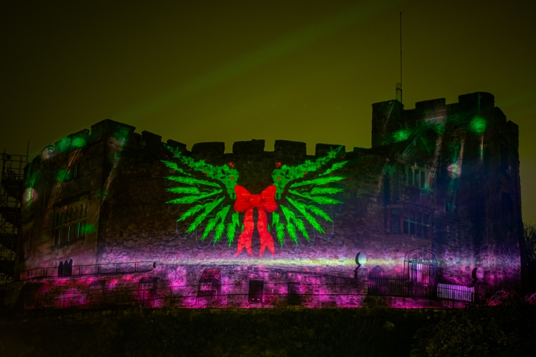 castle with outside projection on the wall and bright lights 