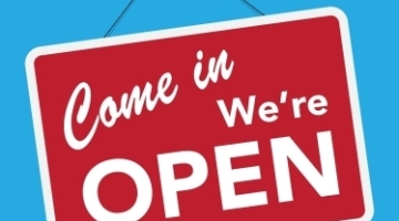 a red sign that says 'come in we're open' on a blue background 
