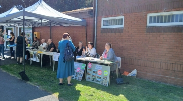 image of a gazebo and people sitting at tables 