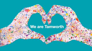 Teal background with heart hands covered in paint splashes