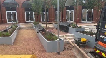image of new paving and planters with trees being laid 