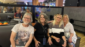 3 people sitting in a venue