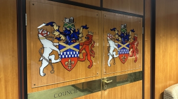 Two wooden doors with 'council chamber'