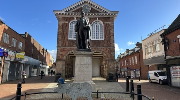 Tamworth town hall with a statue and flowerbed in front of it